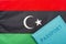 Against the background of the flag of Libya is a passport