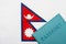 Against the background of the flag of Nepal is a passport