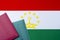 Against the background of the Flag of Tajikistan are passports