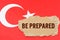 Against the background of the flag of Turkey lies cardboard with the inscription - Be Prepared