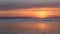 Against the background of the sea, the sun goes down, the waves on the sea at sunset are in the time-lapse. Kotsept of: Sea, Ocean