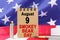 Against the background of the US flag lies cardboard with the inscription - Smokey Bear Day