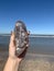 Agate geode gemstone rock gemstones on beach waves sand