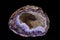 agate semigem geode with crystals isolated on black background