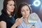 Age woman at consultation with cosmetologist, female with mirror