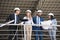 Aged architects in suits talking while standing at construction site