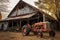aged barn with vintage tractor parked beside