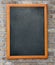 Aged blackboard hanging on brick wall