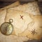 Aged brass nautical compass on table with old maps