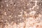 Aged brown peeled stonewall texture background. Old, worn, stone wall structure for backdrop