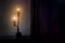 Aged candlestick with warm candle light in dark corner