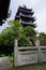 Aged Chinese tower and balustrade by lotus pond in summer