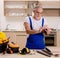 Aged contractor repairman working in the kitchen