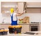 Aged contractor repairman working in the kitchen