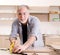 Aged contractor repairman working in the kitchen