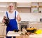 Aged contractor repairman working in the kitchen