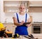 Aged contractor repairman working in the kitchen