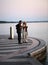 Aged couple on a promenade looking at sunset at Garda Lake in Lazise,