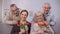 Aged couples hugging and smiling at camera, women holding tulips, celebration