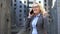 Aged female realtor showing yes gesture talking on phone, business deal approval
