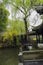 Aged gallery by pond in spring, China