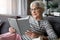 Aged lady enjoying favorite novel at home