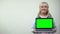 Aged lady showing laptop with green screen, online shopping discounts template