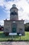 Aged lighthouse stands in the center of a picturesque park in Varberg, Sweden