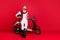 Aged macho man sit on retro moped chatting telephone wear jumper and trousers  red background