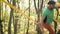 An aged man is trying to stand on a slackline sling to practice balance. The concept of physical development in