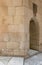 Aged narrow vaulted passage and stone bricks wall