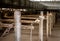 Aged old horse barn interior with wooden stakes in a row