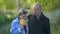 Aged pair of loving man and woman is walking at nature at autumn day, portrait shot