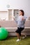 Aged pregnant woman doing exercises at home