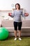 The aged pregnant woman doing exercises at home