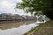 Aged riverside town in cloudy autumn morning