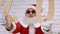 Aged Santa Claus in sunglasses showing 2 and 0 wooden digits