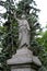 Aged statue of angel monument looking over landscaped acres, Greenridge Cemetery, Saratoga, New York, 2020