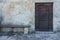 Aged vintage wooden door on stone building cave in Matera, south
