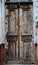 Aged weathered wooden entrance doors with peeling paint