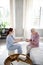 Aged woman feeling thankful to nurse bringing book