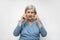 Aged woman in glasses. Elderly lady putting on glasses