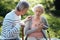 Aged woman having pain in the chest outdoors