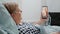 Aged woman holding smartphone with video call