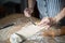 Aged woman`s hands putting the nut filling on the homemade dough for casadielles. Gastronomy