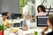 Aged woman, senior intern looking at her female colleague while completing first task at work, Friendly workers