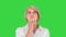 Aged woman thinking and having an idea pointing finger up on a Green Screen, Chroma Key.