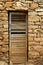 Aged wood door on masonry stone wall