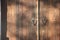 Aged wooden door with rustic style lock closeup
