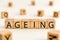 Ageing - word from wooden blocks with letters
